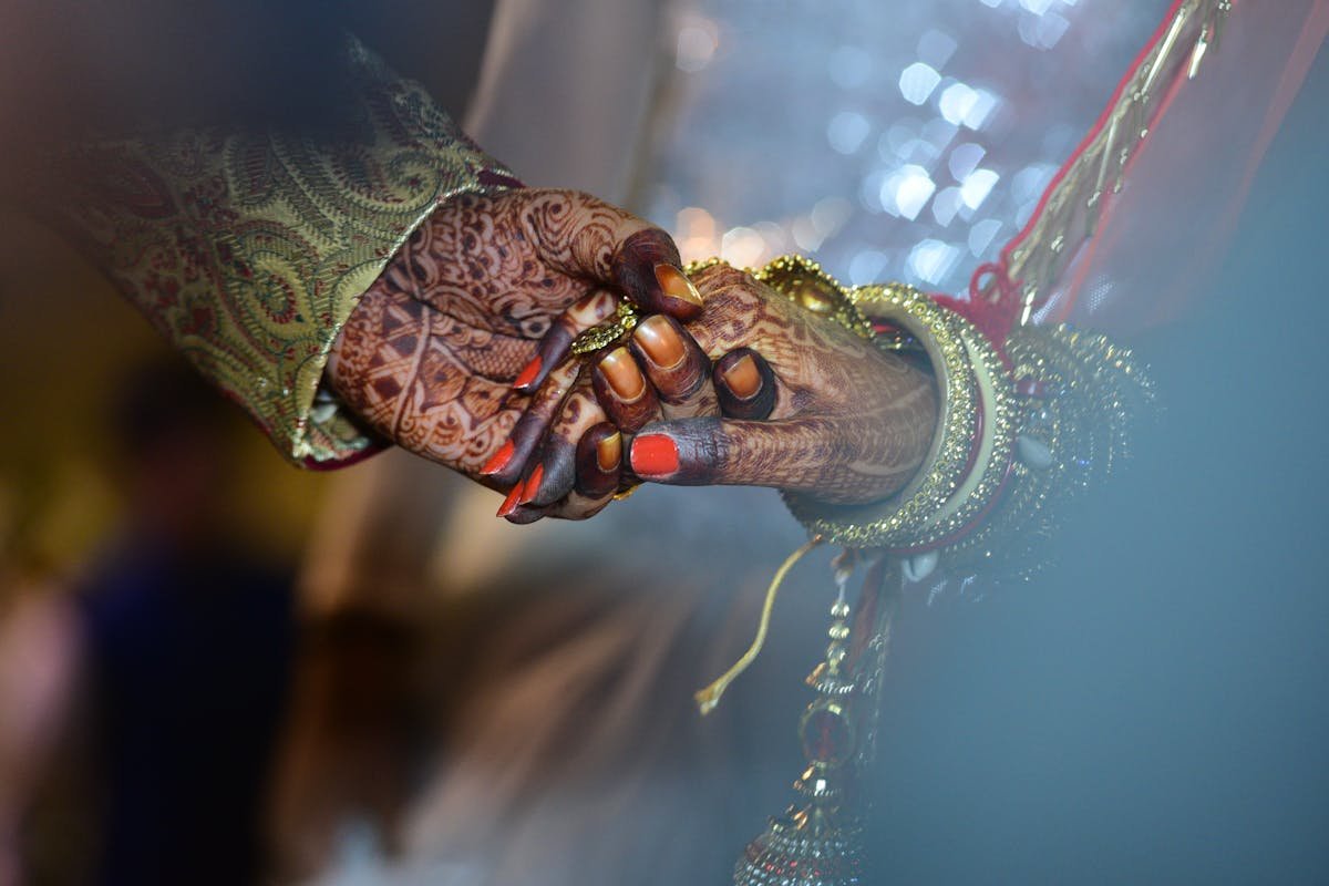 Mehendi ceremony with intricate henna designs